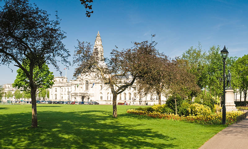 Magnificent City Hall in the heart of the Cardiff Welsh and European flags visible.